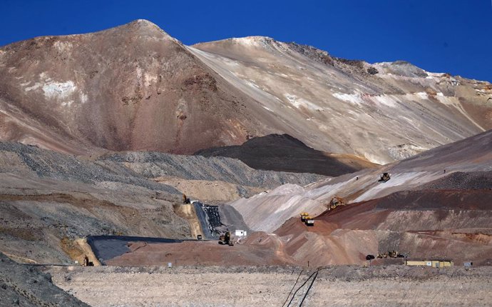 Dump trucks and bulldozers operate at Barrick Gold Corp's Veladero gold mine in
