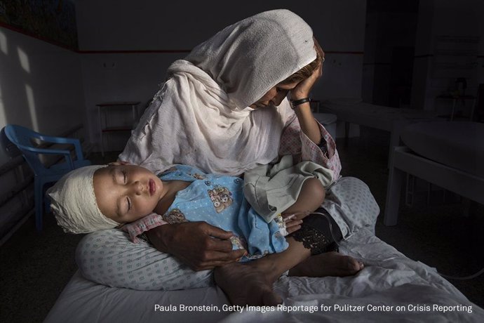 KABUL, AFGHANISTAN -MARCH 29, 2016:  A the Emergency hospital Najiba holds her n