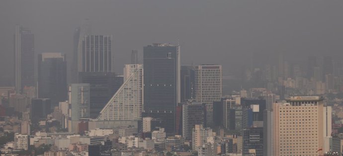 Buildings stand shrouded in smog during an environmental contingency day in Mexi