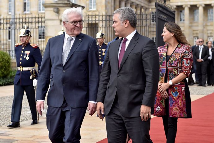 German President Frank-Walter Steinmeier walks alongside Colombian President Iva