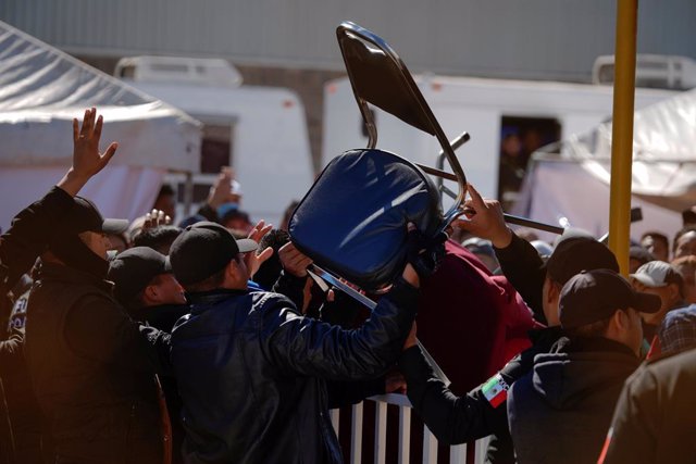 Migrants clash with security agents at a provisional shelter in Piedras Negras,