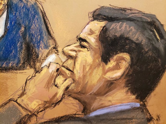 The accused Mexican drug lord Joaquin "El Chapo" Guzman listens to a testimony b