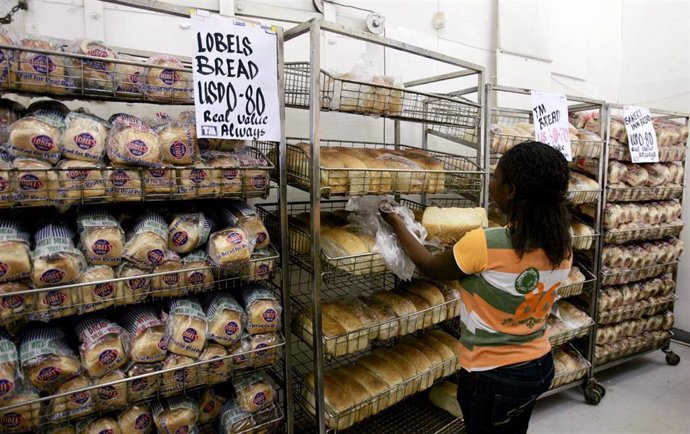 Una mujer ordena el pan en un supermercado de Harare