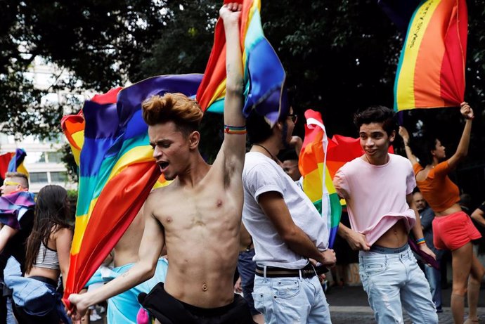 Revellers dance as they take part in the Gay Pride parade along Paulista Avenue 