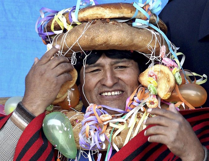 Bolivia's President Evo Morales wears a traditional headdress and wreath made of