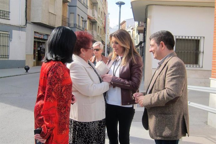 Susana Díaz, junto a Francisca Medina y Francisco Reyes, saluda a una vecina de 
