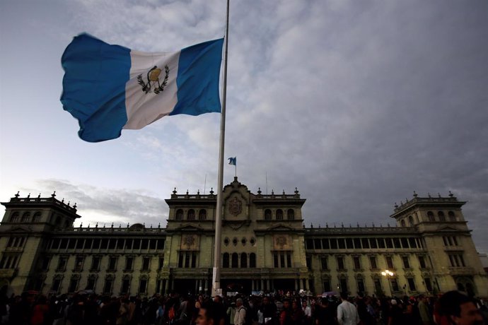 The Guatemalan flag flies at half-staff during a protest to demand justice for t