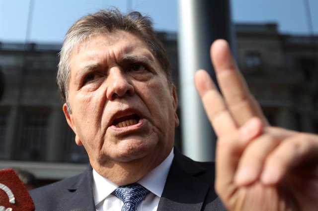 Former Peruvian president Alan Garcia talks to the media as he arrives at the Na