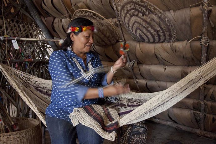 Ecuador's Waorani Indian leader Manuela Omare Ima shows how to use a native arro