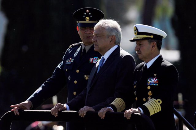 Mexico's new President Andres Manuel Lopez Obrador review troops flanked by Secr