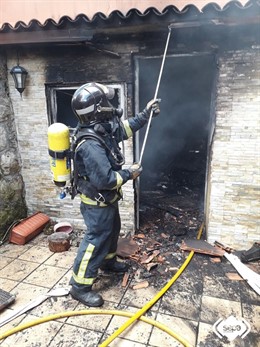 Sucesos.- Los bomberos apagan el fuego en un incendio en Avilés