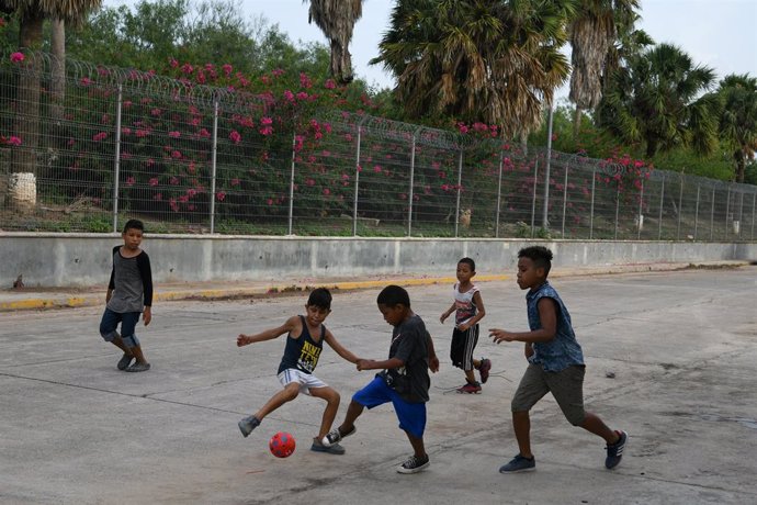 Niños migrantes juegan al fútbol en la localidad mexicana de Matamoros