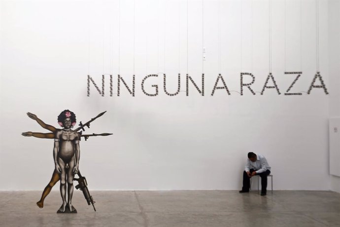 A security guard sits next a sculpture at the University Museum of Contemporary Art in Mexico City