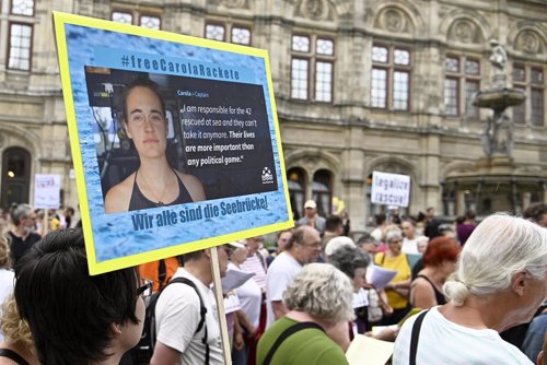 02 July 2019, Austria, Vienna: People hold placards during a demonstration to call on the Italian authorities to release Sea Watch captain Carola Rackete. Photo: Hans Punz/APA/dpa