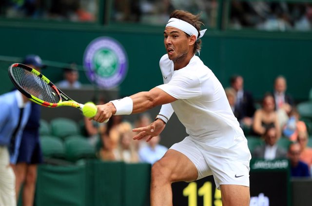 06 July 2019, England, London: Spanish tennis player Rafael Nadal in action against France's Jo-Wilfried Tsonga during their men's singles round of 32 match on day six of the 2019 Wimbledon Grand Slam tennis tournament at the All England Lawn Tennis and C