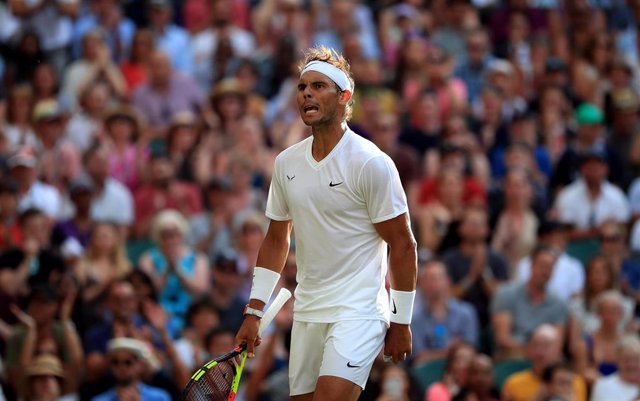 04 July 2019, England, London: Spanish tennis player Rafael Nadal in action against Australian Nick Kyrgios during their men's singles round of 64 match on day four of the 2019 Wimbledon Grand Slam tennis tournament at the All England Lawn Tennis and Croq