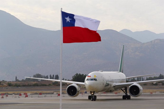 The flag of Chile flutters as a plane transporting Pope Francis prepares to park after his arrival in Santiago