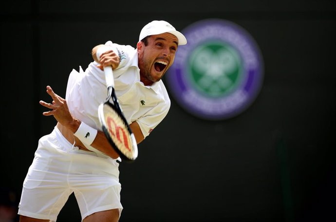 10 July 2019, England, London: Spanish tennis player Roberto Bautista Agut in action against Argentina's Guido Pella during their men's singles quarter-final match on day nine of the 2019 Wimbledon Grand Slam tennis tournament at the All England Lawn Te