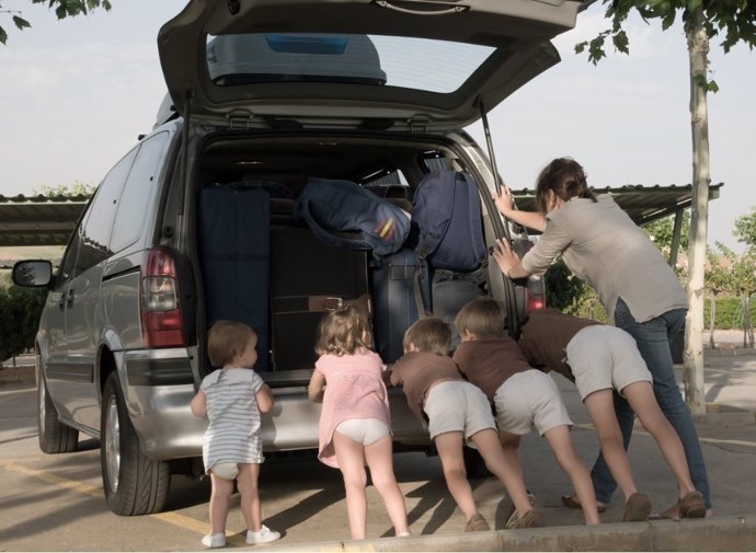 Una familia numerosa cargando un vehículo
