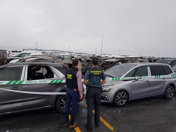 Agentes de la Guardia Civil de Pontevedra inspeccionan los vehículos calcinados en Bouzas