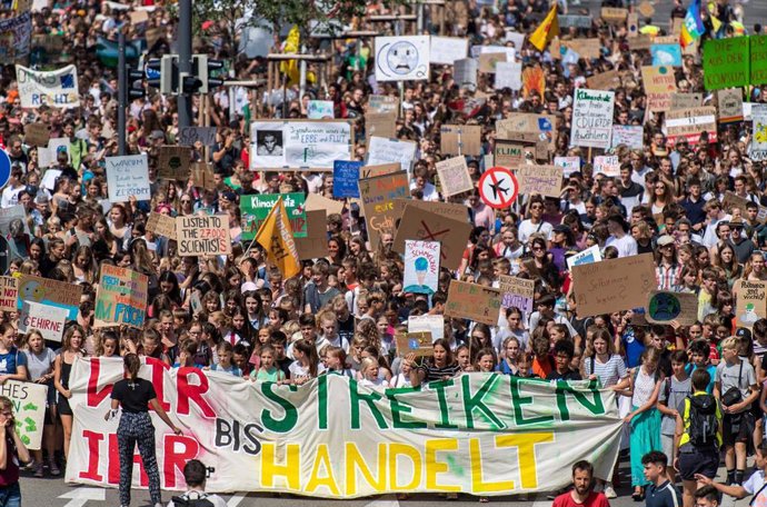 19 July 2019, Baden-Wuerttemberg, Freiburg: Participants hold placards during the Fridays for Future - climate strikes for the implementation of the Paris World Climate Agreement. Photo: Patrick Seeger/dpa