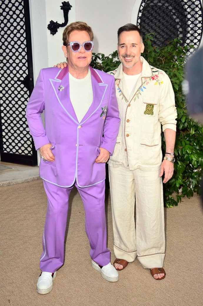 24 July 2019, France, Antibes: British singer Elton John (L)and his partner David Furnish attends the Elton John Aids foundation Midsummer Party at Jean Pigozzi's Villa Dorane. Photo: Matt Crossick/PA Wire/dpa
