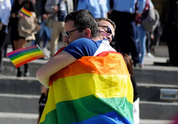 People hug during the second LGBT Pride Parade in Pristina
