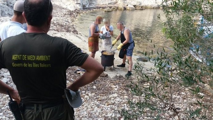 Agentes de Medio Ambiente en Cala Figuera paralizando un grupo de personas que intentaba cocinar