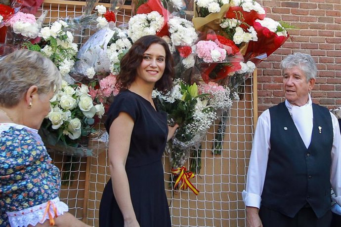 La presidenta de la Comunidad de Madrid, Isabel Díaz Ayuso (c), participa en la ofrenda floral ante el cuadro de la Virgen de la Paloma en la capital.