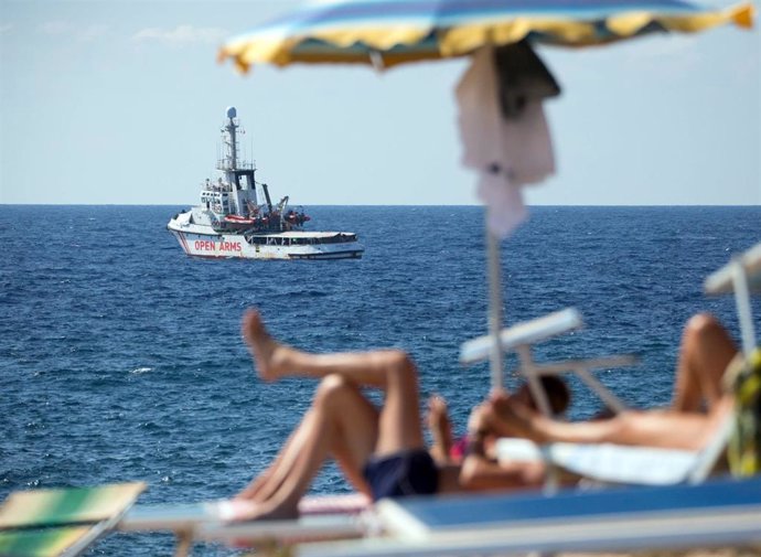 20 August 2019, Italy, Lampedusa: The ship "Open Arms" of aid organisation Proactiva Open Arms waits near Lampedusa island. Migrants are jumping out of desperation from the rescue boat, stranded off Italy's Lampedusa island, the charity running the vess