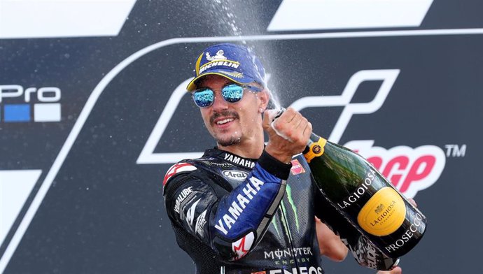 25 August 2019, England, Towcester: Spanish motorcycle racer Maverick Vinales of Movistar Yamaha celebrates on the podium after coming in third during the 2019 British motorcycle Grand Prix at Silverstone Circuit. Photo: Bradley Collyer/PA Wire/dpa