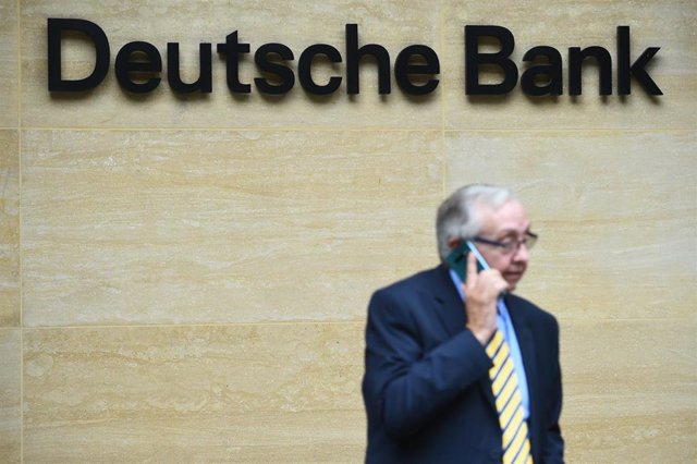 08 July 2019, England, London: A man talks with his mobile in front of the London office of the Deutsche Bank after Germany's largest money house had announced on the 7th of July in the course of a radical restructuring of the group the reduction of aroun