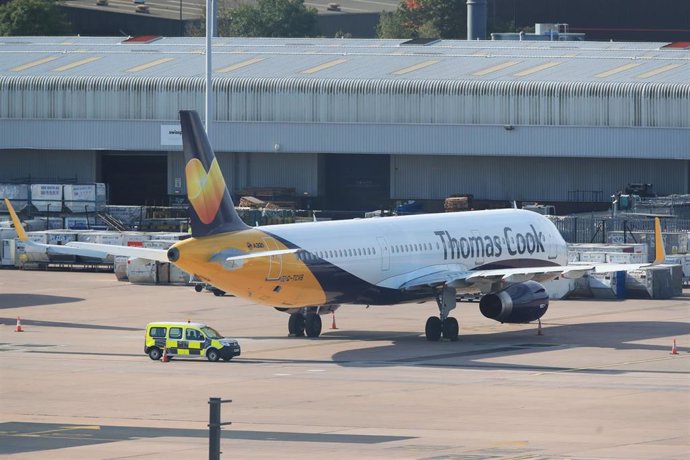 23 September 2019, England, Manchester: An Airbus A321 from the airline Condor with the design of the tourism company Thomas Cook stands on the tarmac at  Manchester Airport. Thomas Cook, one of Britain's biggest travel firms, filed for liquidation earl