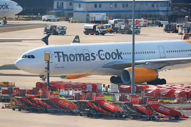 23 September 2019, England, Manchester: An Airbus A330 from the airline Condor with the design of the tourism company Thomas Cook stands on the tarmac at  Manchester Airport. Thomas Cook, one of Britain's biggest travel firms, filed for liquidation early 