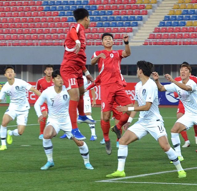 15 October 2019, North Korea, Pyongyang: North korea's Pak Kwang-ryong (3rd R) and Jong Il-gwan in action aganist South korea's Hwang Ui-jo (2nd R) and Son Heung-min (2nd L), during the 2022 FIFA World Cup Asian qualification group H soccer match at Kim I