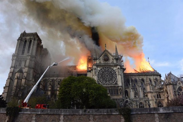 HANDOUT - 15 April 2019, France, Paris: A picture released by French Ministry of the Interior shows smoke and flames rise from the landmark Notre-Dame Cathedral as a fire brigades try to extinguish a fire that has broken out in the Cathedral, potentially 
