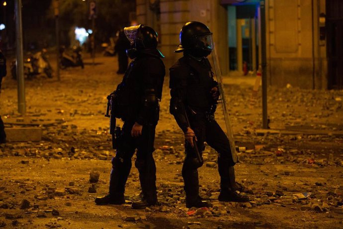 Dos policías durante los disturbios, en Barcelona (España) a 18 de octubre de 2019.