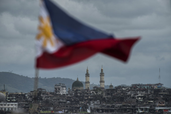 The Philippine flag is seen waving over the besieged city of Marawi - GETTY / Jes Aznar