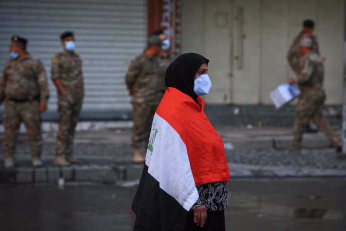 Una mujer envuelta con la bandera iraquí en las protestas en Bagdad