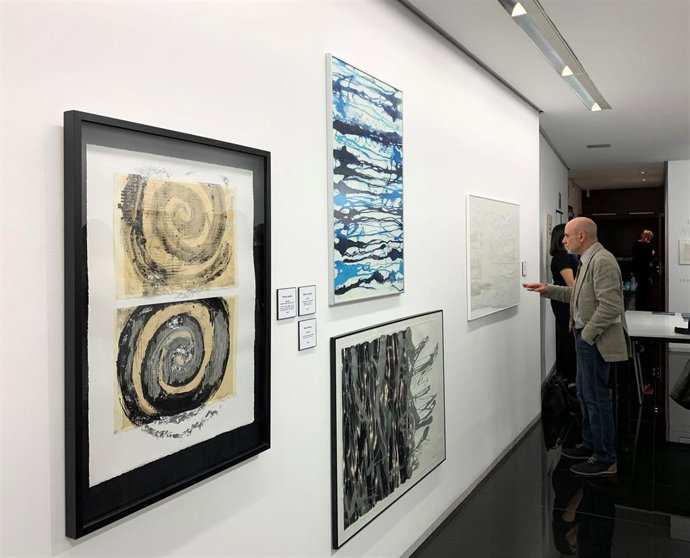 Un hombre observa uno de los grabados de la exposición 'Atlántico. España-Portugal', que reúne en el Teatro Zorrilla la obra gráfica de 14 artistas de ambos países.