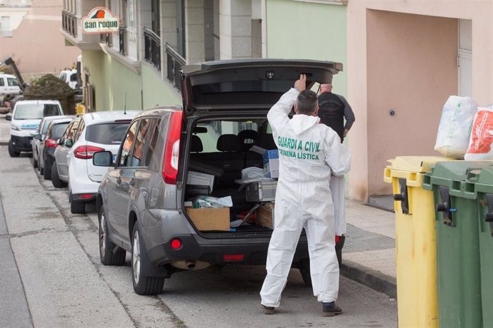 Un trabajador de Criminalística de la Guardia Civil en el maletero de su coche antes de entrar a la vivienda donde un menor de edad asesinó presuntamente a su madre la pasada noche del domingo al lunes, en el número 3 de la calle Costa do Castro, en la 