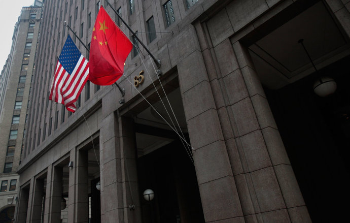 The flag of the People's Republic of China hangs next to an American flag outside the Goldman Sachs headquarters building