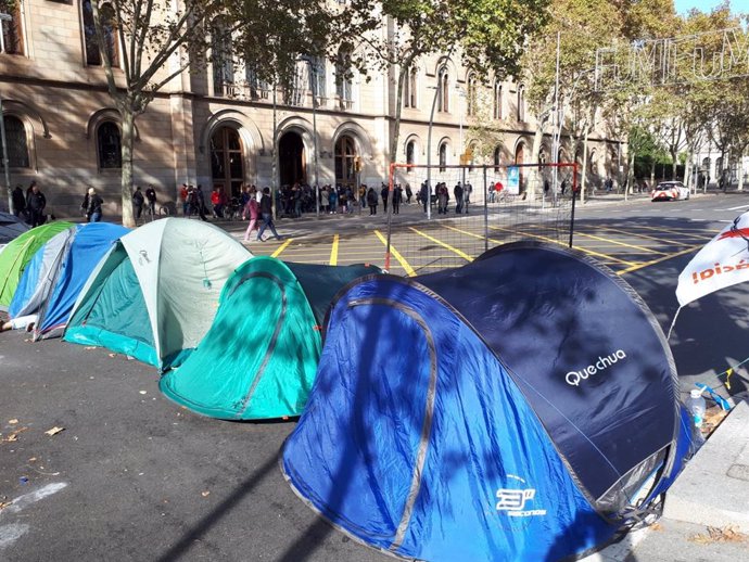Joves acampats a la plaa Universitat de Barcelona prop d'una cua de votants el dia de les eleccions generals del 10 de novembre de 2019