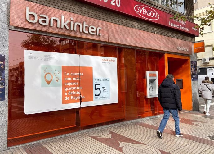 Un hombre camina junto a una oficina del Bankinter en Madrid.