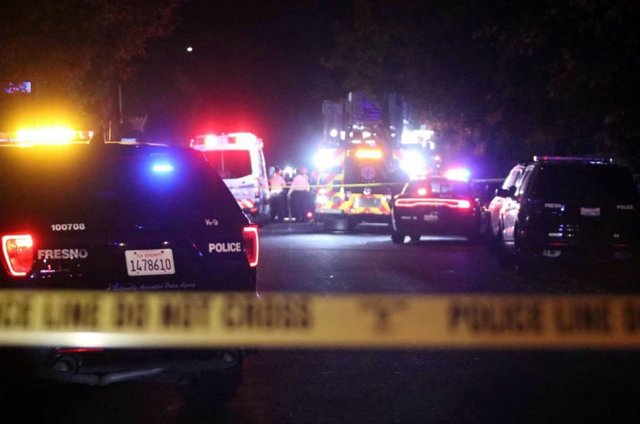  Police and rescue vehicles stand at the scene of a shooting in the southeast of Fresno