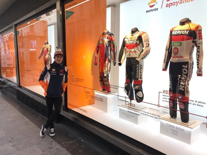 Marc Márquez posa junto al escaparate con monos históricos del Repsol Honda