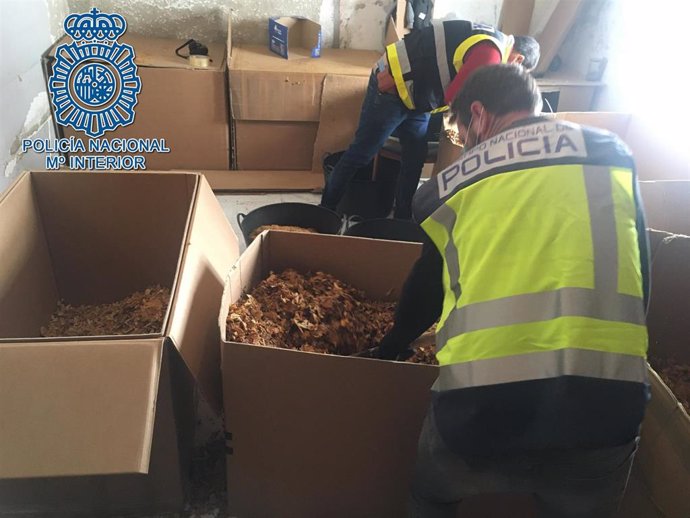 Agentes de la Policía Nacional inspeccionan cajas con picadura de tabaco.