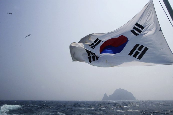 A South Korean flag flies from a South Korean coast 
