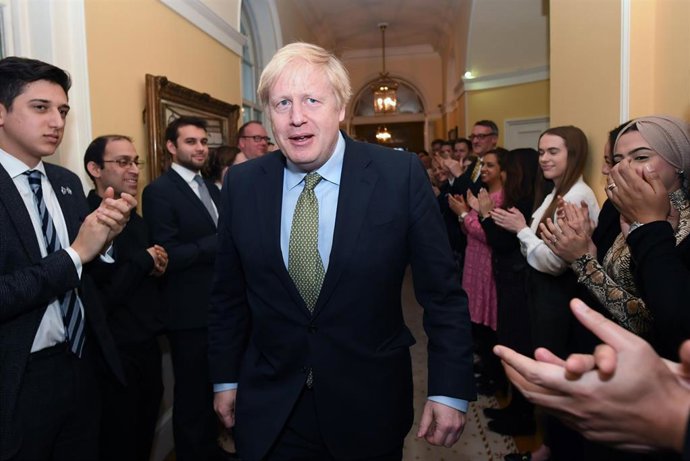 13 December 2019, England, London: Staff of 10 Downing Street greet UK Prime Minister Boris Johnson upon his arrival from Buckingham Palace where he was invited by Queen Elizabeth II to form a Government, after the Conservative Party was returned with a