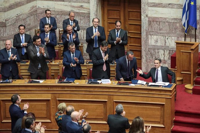 El primer ministro griego Kyriakos Mitsotakis es aplaudido por los ministros de su Gobierno después de su discurso durante una sesión parlamentaria antes de la votación presupuestaria.